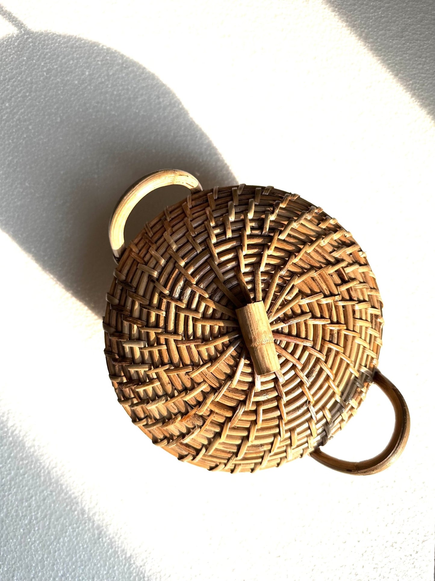 Cane roti box with handles and lid.